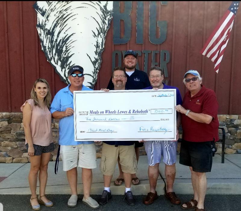On hand for the Fins Hospitality Group check presentation to Meals on Wheels Lewes-Rehoboth are (l-r) Dasha Sopinskyy, Jeff Hamer, Eric Camper and Mike Anderson of FHG with MOWLR board members John Wolfle and Bob Yesbek. SUBMITTED PHOTO